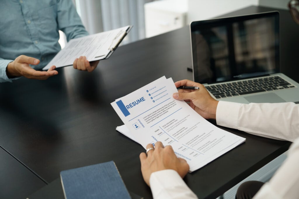 Examiner reading a resume during job interview at office Business and human resources concept.